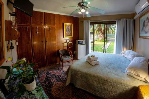 a bedroom with a bed with a teddy bear on it at Melsetter's Guesthouse in Bloemfontein