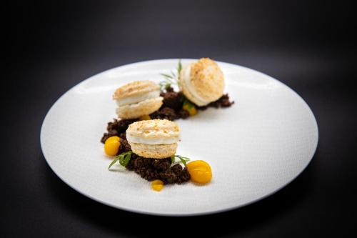 a white plate with some food on a table at Hôtel Mercure Rochefort La Corderie Royale in Rochefort