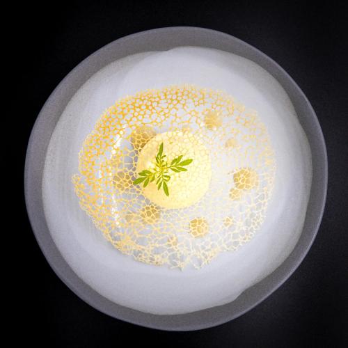 a white plate with a cake on a table at Hôtel Mercure Rochefort La Corderie Royale in Rochefort