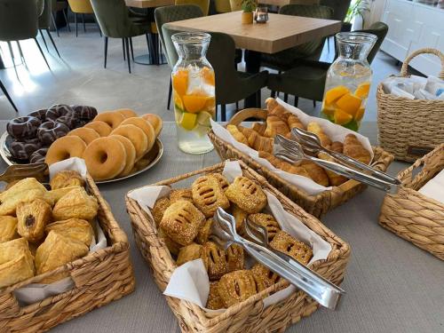 a table with baskets of different types of bread and pastries at Panorama Hill Hotel in Iraklitsa