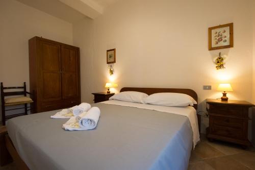 a bedroom with a bed with towels on it at ABBAZIA DI VALLINGEGNO in Gubbio
