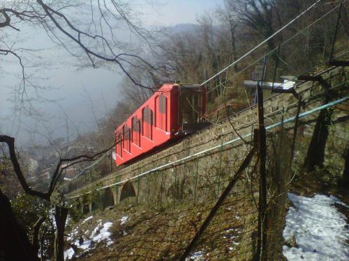 a red train on a bridge in the snow at La Canarina Bed & Breakfast in Como