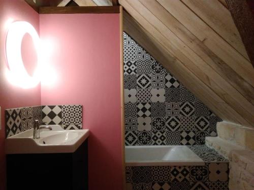 ein Badezimmer mit einem Waschbecken und einer Badewanne in der Unterkunft La Ferme des Augustines in Belluire