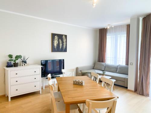 a living room with a table and a couch at Sunny apartment in Bečići