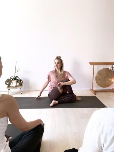 a woman sitting on the floor in a room at RUNO Hotel Porvoo in Porvoo