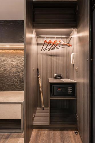 a walk in closet with a wooden wall at Aspira Gems Center Silom in Bangkok