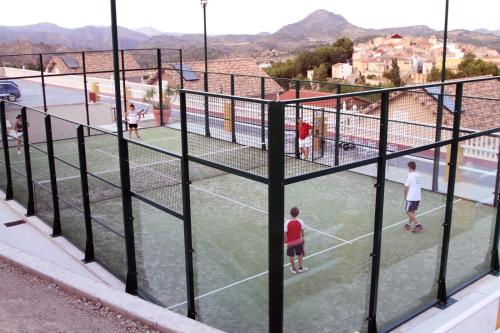 a group of people playing tennis on a tennis court at Finca La Ecarada. Férez (Albacete) in Férez