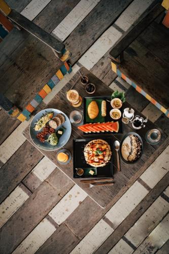 an overhead view of a table with plates of food at Inhale @ Hill in Koh Mook
