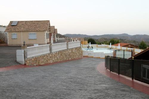 a patio with a retaining wall and a swimming pool at Finca La Ecarada. Férez (Albacete) in Férez