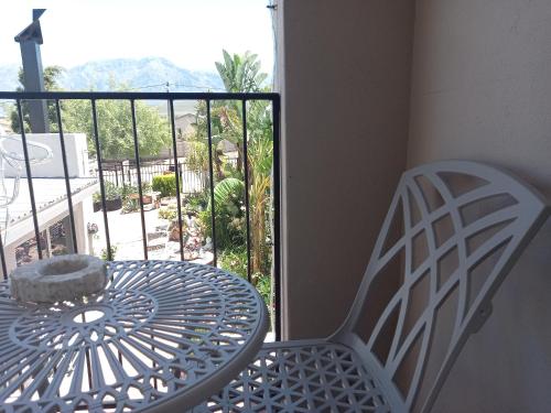 a table and a chair on a balcony with a view at Mountainia Inn in Worcester