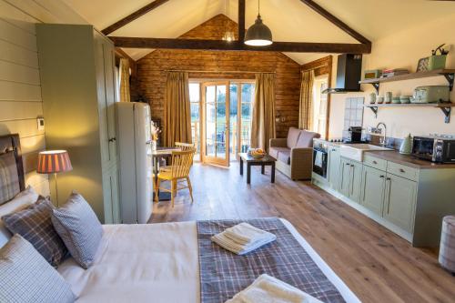 a kitchen and a living room with a couch and a table at Wildlands Galway in Moycullen