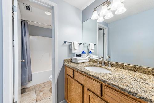 a bathroom with a sink and a mirror at Phoenix X 907 in Orange Beach