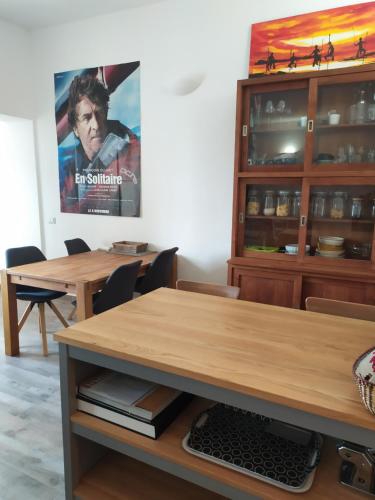 a dining room with a table and a movie poster at la Casa Amaranto in SantʼAntìoco