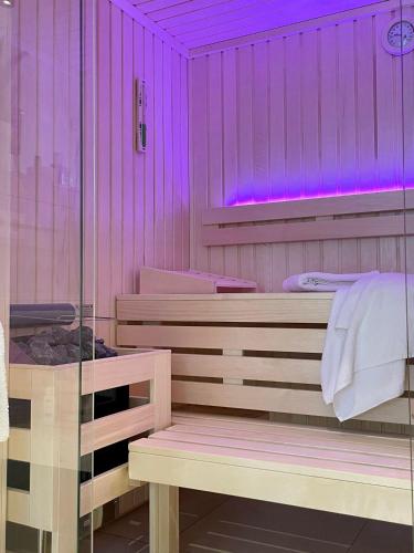a sauna with purple lighting in a room at NEU! Feriendomizil TraumZeit 2 mit Sauna & Garten in Göhren-Lebbin