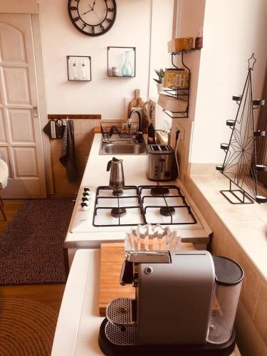 a kitchen with a stove top oven and a sink at Larix Mátra Vendégház in Matraszentlaszlo