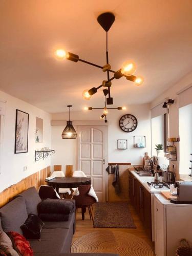 a living room with a couch and a ceiling fan at Larix Mátra Vendégház in Matraszentlaszlo