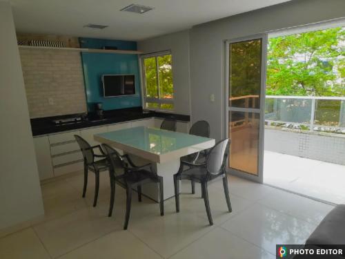 a kitchen with a table and chairs in a room at Beira Mar Premium Apart - Solar do Atlântico Tambaú in João Pessoa