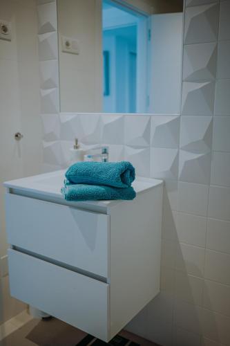 a bathroom with a sink and a towel on a counter at Panorama Mar Apartment in Punta Prima
