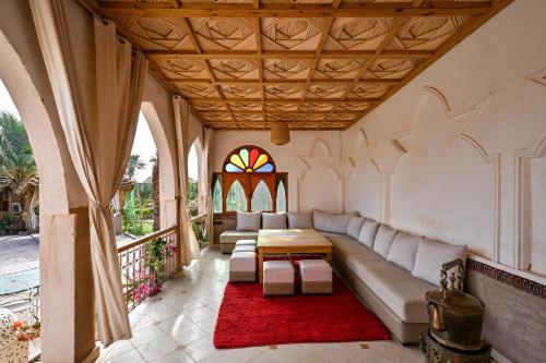 a living room with a couch and a table at Sbai Palace in Mhamid