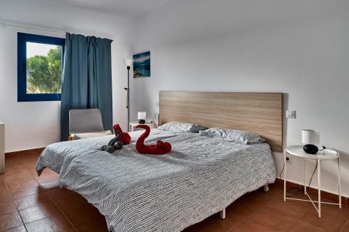 a bedroom with a red stuffed animal on a bed at CostaSun and Pool in Costa Calma