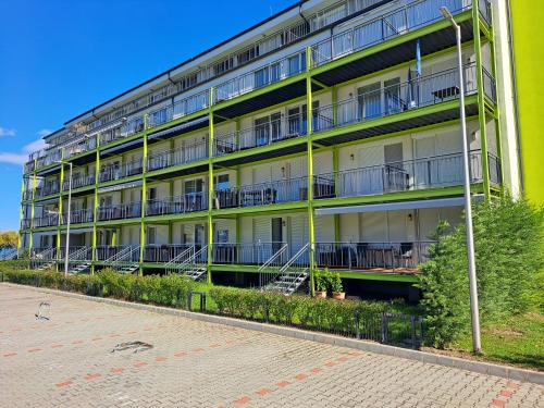an apartment building with balconies on the side of it at Silver Apartman in Siófok