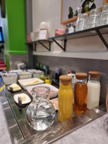 a counter with three bottles of milk and cheese at ibis Styles Le Puy en Velay in Le Puy en Velay