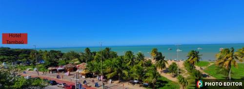 a view of a beach with palm trees and the ocean at Beira Mar Premium Apart - Solar do Atlântico Tambaú in João Pessoa