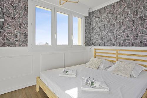 a bedroom with a bed with two towels on it at Nice apartment in the center of Biarritz - Welkeys in Biarritz