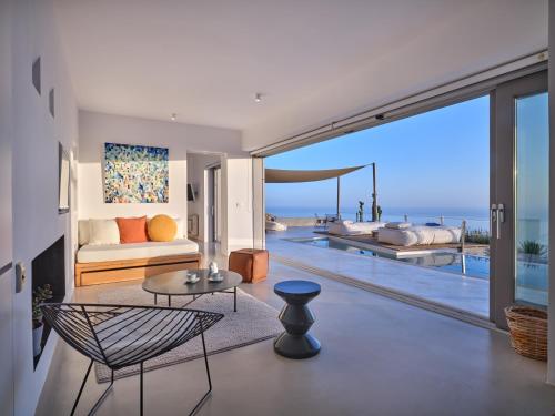 a living room with a view of the ocean at Santorini Heights in Pirgos