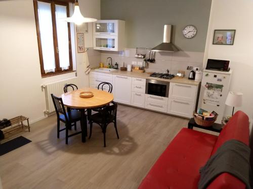 a kitchen with a table and chairs in a room at Ca' Rosone in Imola