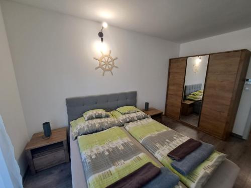 a bedroom with a bed and a large mirror at Silver Apartman in Siófok