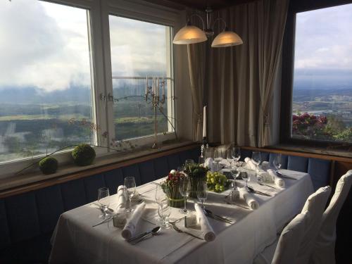 a dining room with a table with a white table cloth at Panoramahotel Steirerland in Kitzeck im Sausal