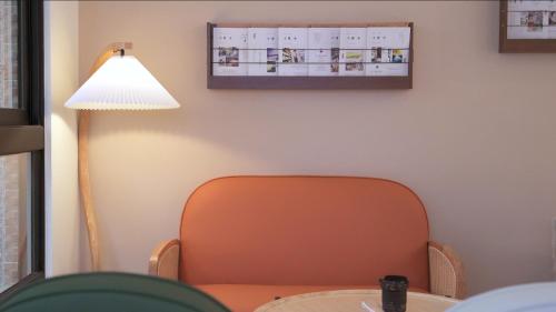 a chair sitting at a table next to a lamp at 咻咻宿 Xiuxiu 電梯宅 in Taitung City