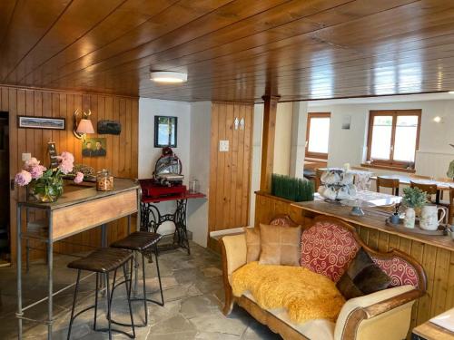 a living room with a couch and a table and a kitchen at Täschalp Restaurant&Lodge in Täsch