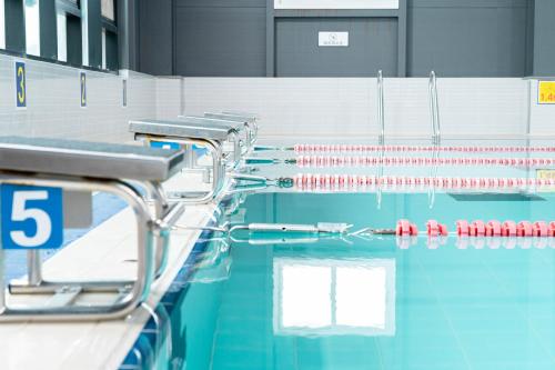 a swimming pool with a row of red and white paddles at Bedradio Dodubong in Jeju