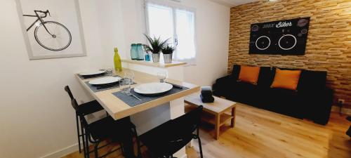a living room with a table and a couch at Zen Studio Le Granier Challes Centre - Parking in Challes-les-Eaux