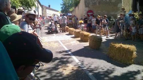 a crowd of people looking at a group of hay bales at Gîte de Claire in Lectoure