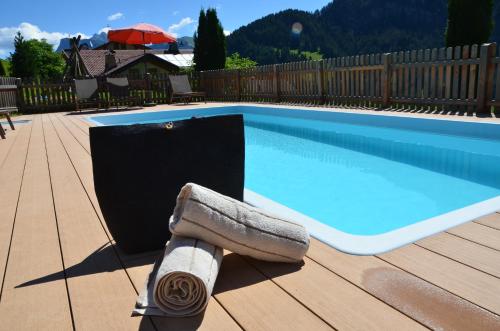 a towel laying next to a swimming pool at Residence Rumanon in Ortisei