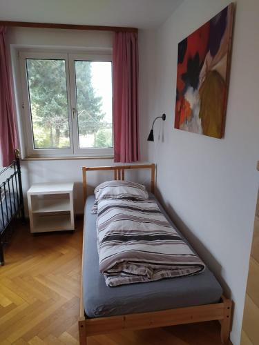a bed sitting in a room with a window at Ferienhaus Günter in Forchtenberg