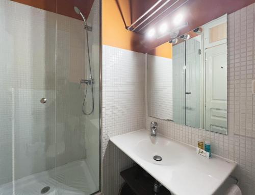 a bathroom with a sink and a shower and a mirror at Stay U-nique Apartments Borbó II in Barcelona