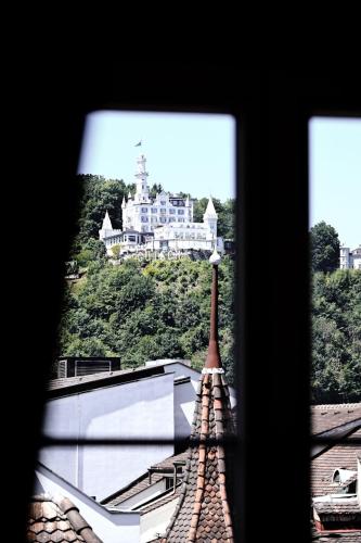 a view from a window of a building with a castle at The Lubo - self check-in in Luzern