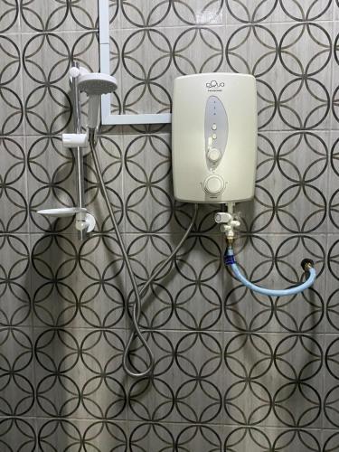 a bathroom with a soap dispenser on a wall at SBS HOTEL in Padang Besar