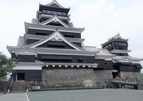 a large building with two towers on top of it at Hotel Okus in Kumamoto