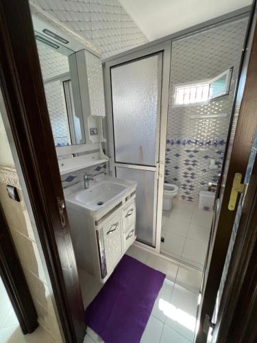 a bathroom with a sink and a toilet at Appartement boulaàyoun de luxe à louer nador 3 in Nador