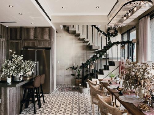 a dining room with tables and chairs and a staircase at WR Light Travel Warm Rice in Suao