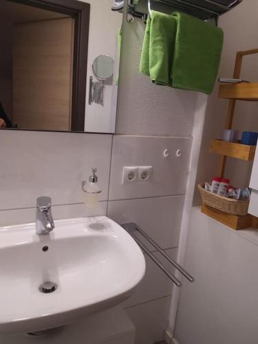 a bathroom with a white sink and a mirror at Kleine Auszeit in Lauben