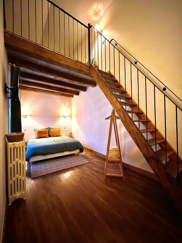 a bedroom with a bed and a staircase at Chambres Privées des HAMY au coeur du parc national ENTRÉE AUTONOME in Arc-en-Barrois