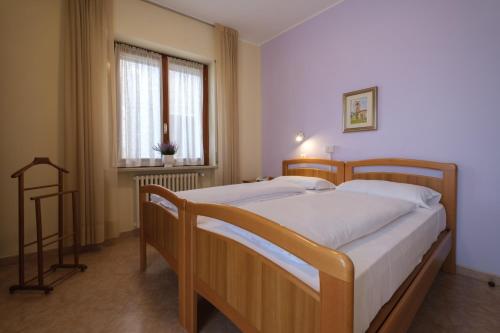Кровать или кровати в номере Casa Vacanza - Casa del Padre Nascimbeni