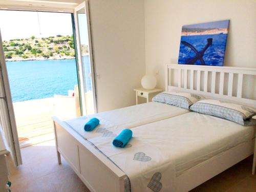 a bedroom with a bed with a view of the ocean at Apartment Tranquillo in Vela Luka