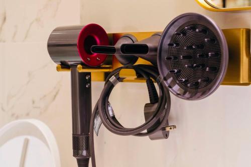 a hair dryer hanging on a wall at WR Light Travel Warm Rice in Suao